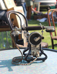 Close-up of antique telephone on table in yard