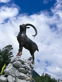 Low angle view of statue against rock