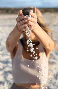 Midsection of woman holding water