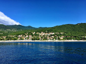 View of calm sea against mountain range