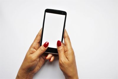 Midsection of person using smart phone against white background