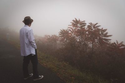 Man standing on road against sky