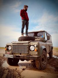 Full length of man standing on land against sky