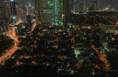 Aerial view of illuminated buildings in city at night