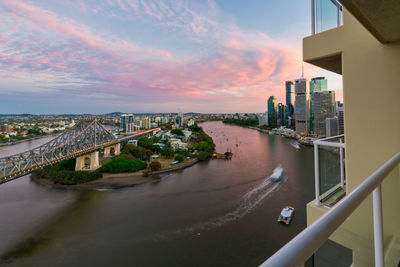 High angle view of river amidst buildings in city against sky