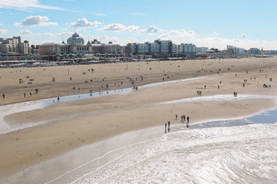 People on beach against sky