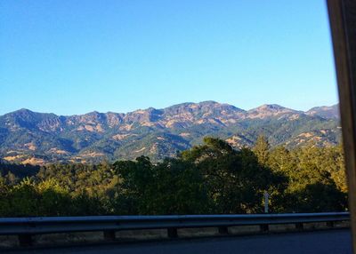 Scenic view of mountains against clear blue sky