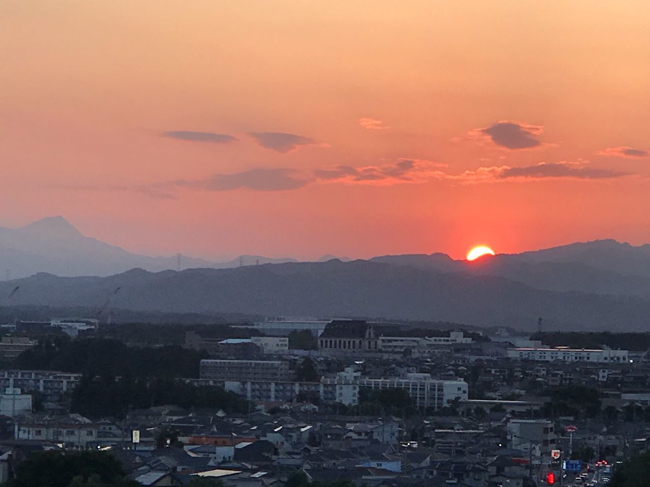 sky, architecture, sunset, building exterior, city, mountain, built structure, residential district, nature, cloud - sky, high angle view, building, beauty in nature, cityscape, orange color, no people, scenics - nature, mountain range, outdoors, sun, romantic sky, townscape