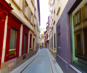 Narrow street amidst buildings in city