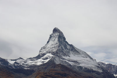 Low angle view of snowcapped mountain against sky