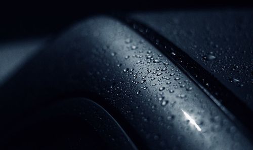 Close-up of raindrops on car windshield