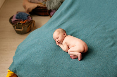 High angle view of baby sleeping on bed
