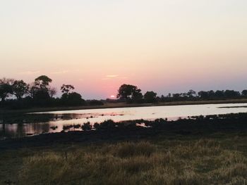 Scenic view of lake against sky during sunset