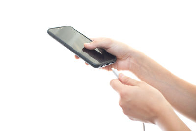 Midsection of person using mobile phone against white background