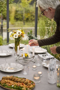 Rear view of woman having food on table