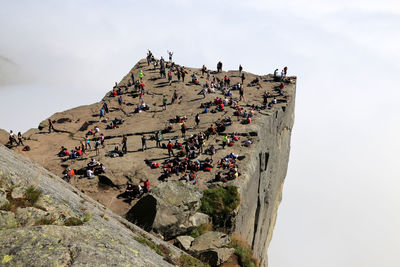 High angle view of people on preikestolen during foggy weather