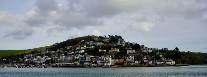 Panoramic shot of townscape by sea against sky