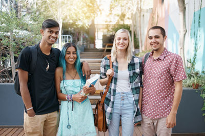 Portrait of smiling friends in campus