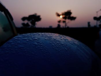 Close-up of silhouette car against sky at sunset