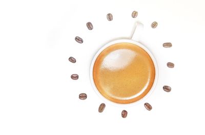 Directly above shot of coffee cup against white background