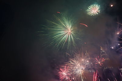 Low angle view of firework display at night