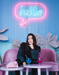 Portrait of woman having drinks on table in cafe