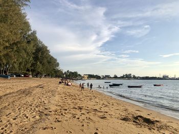 People on beach against sky