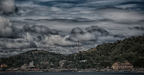 Scenic view of mountains and buildings against sky