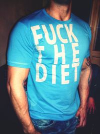 Midsection of man standing with text