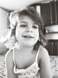 Portrait of cute girl smiling on bed at home