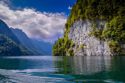 Scenic view of lake by mountain against sky