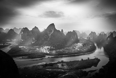 Panoramic view of sea and mountains against sky