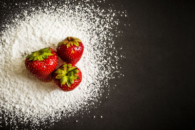 Close-up of strawberry over black background