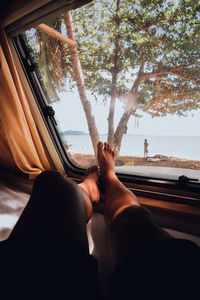 Low section of woman relaxing in motor home