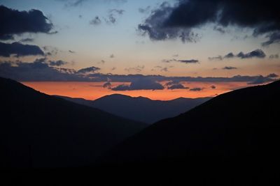 Scenic view of silhouette mountains against sky during sunset