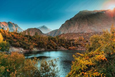 Scenic view of lake and mountains against sky