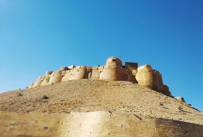 Low angle view of historical building against blue sky