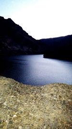 Scenic view of lake and mountains against clear sky