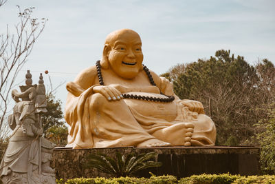 Statue of buddha against trees