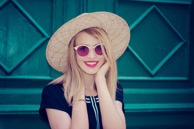 Portrait of smiling young woman wearing hat