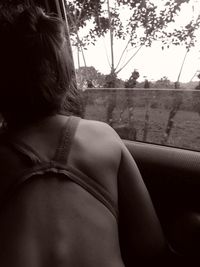 Rear view of woman relaxing in car