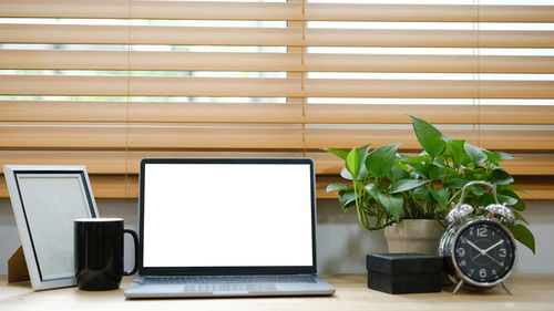 Laptop and books on table