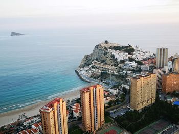 High angle view of sea and buildings against sky