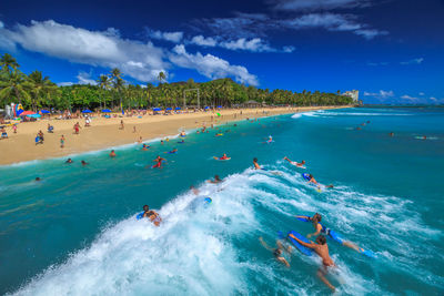 Panoramic view of people enjoying at beach