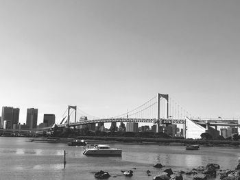 View of suspension bridge with city in background