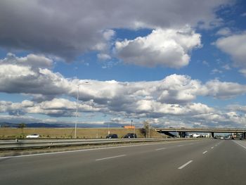 View of highway against cloudy sky