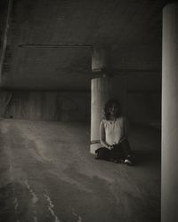 Girl holding toy while sitting on floor