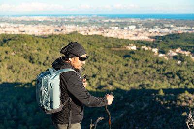 Rear view of woman standing on field