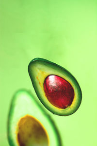 Close-up of apple against green background