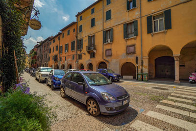 Cars on street by buildings in city